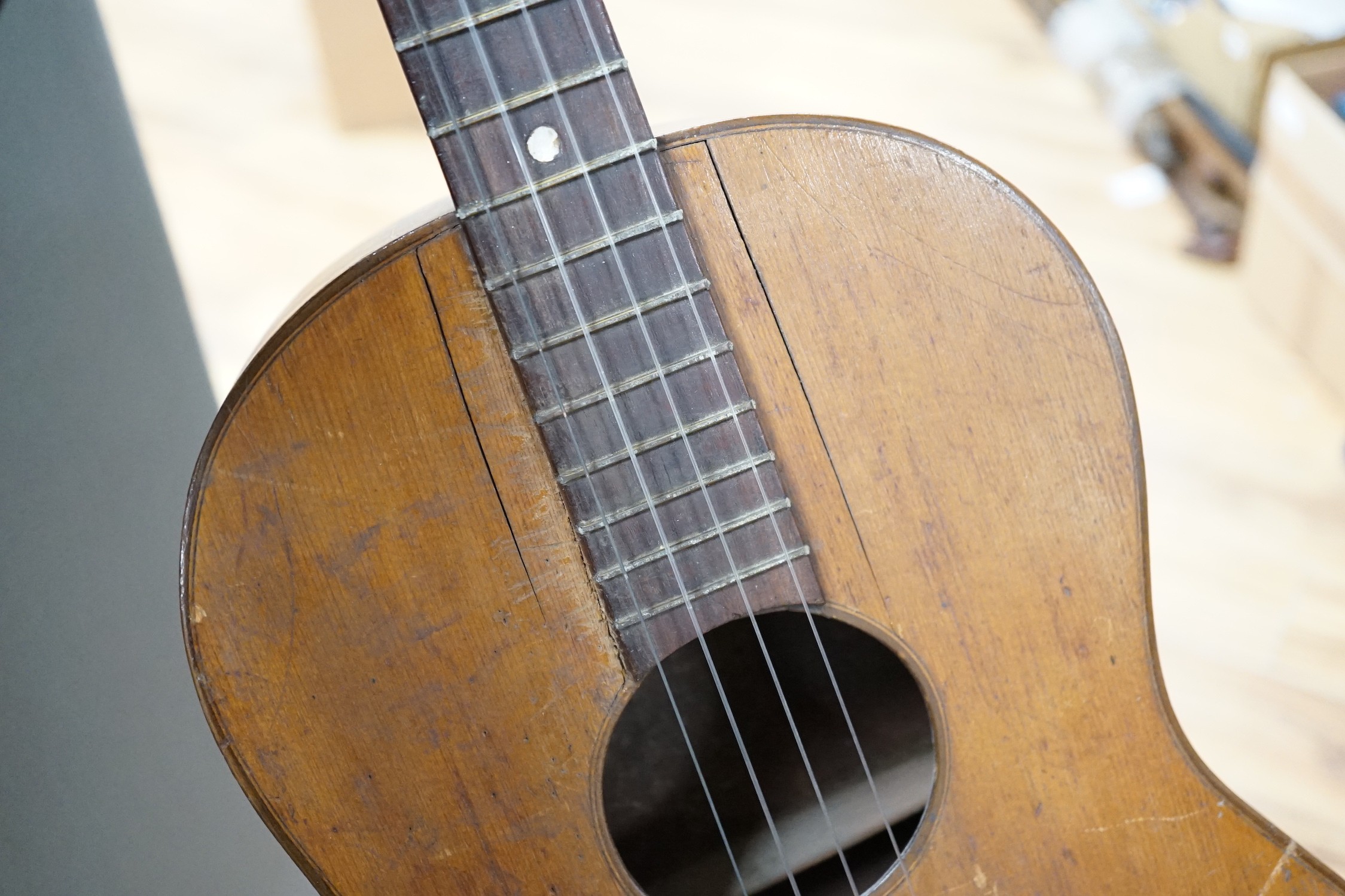 A four string banjo style parlour guitar